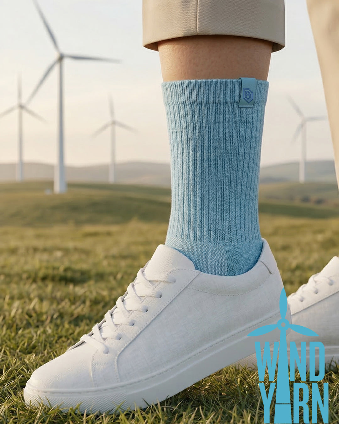Black Bulg Wind Yarn crew sock paired with white sneaker on grass, wind turbines in background