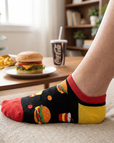 Socksop Burger ankle socks at home — black pair styled with takeout meal scene