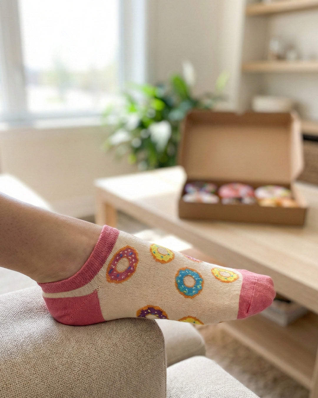 Socksop Donut ankle socks at home — cream pair styled with sweet treat indoor scene