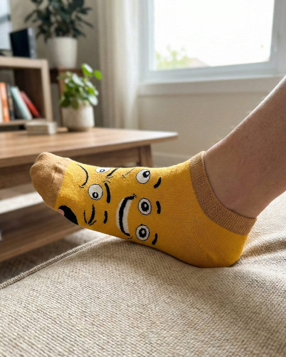 Socksop Emoji ankle socks at home — yellow pair styled with relaxed indoor cue