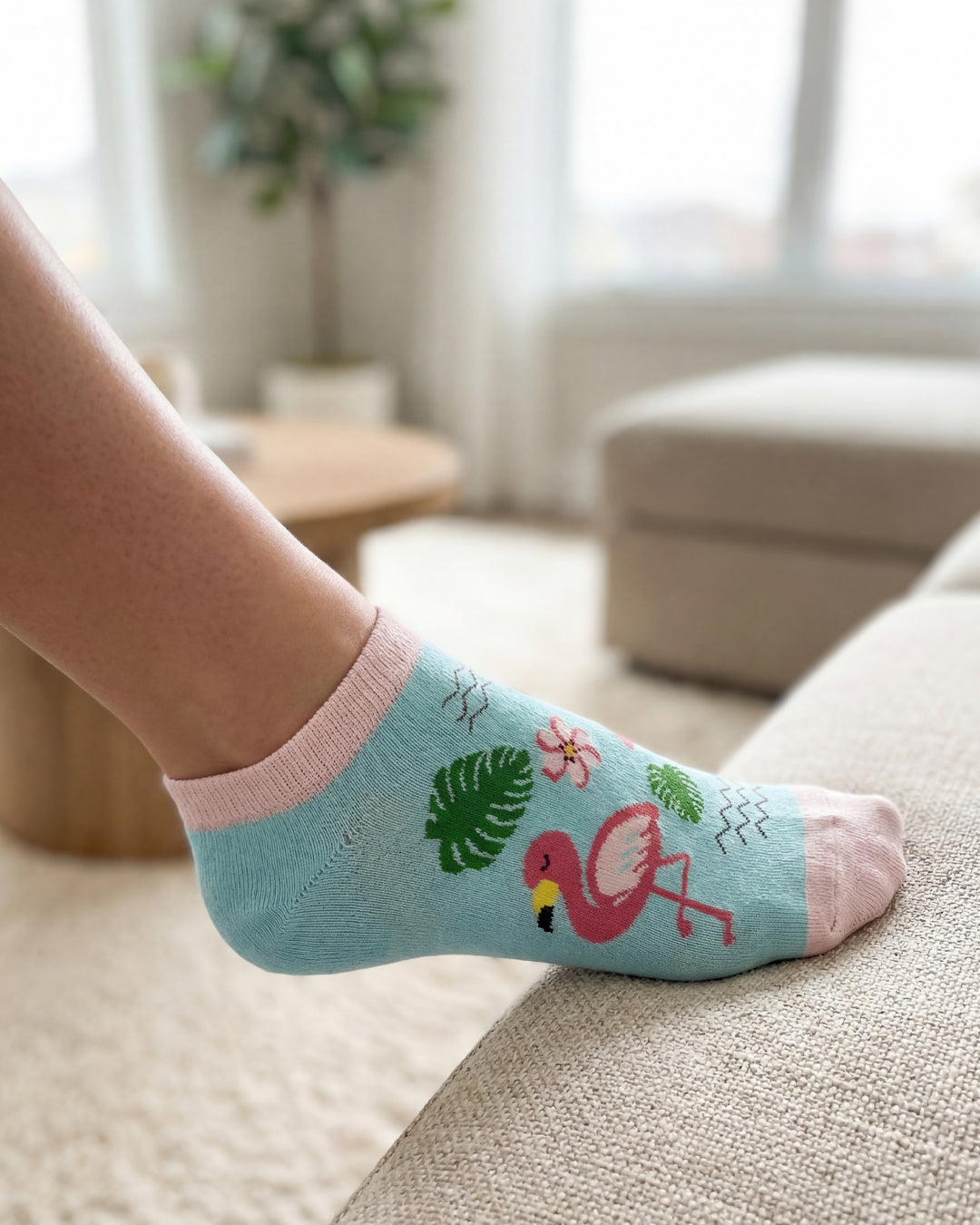 Socksop Flamingo ankle socks at home — turquoise pair styled with tropical indoor scene