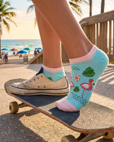 Socksop Flamingo ankle socks lifestyle shot — turquoise pair styled with breezy tropical outfit