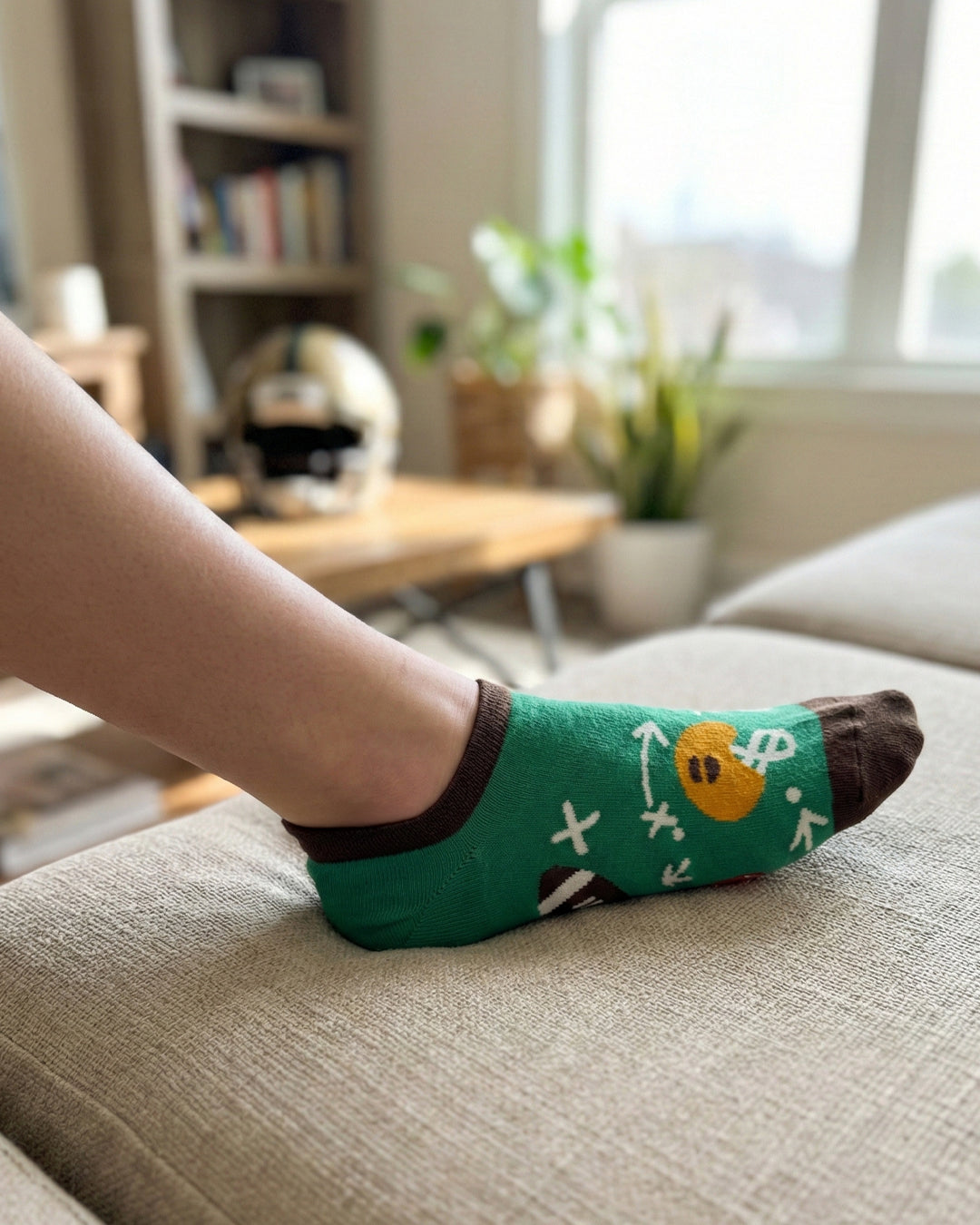 Socksop Football ankle socks at home — green pair styled for game-day indoor watch