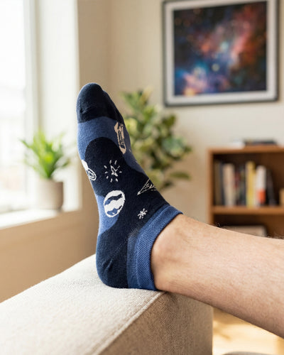 Socksop Space ankle socks at home — navy pair styled with cosmic indoor cue