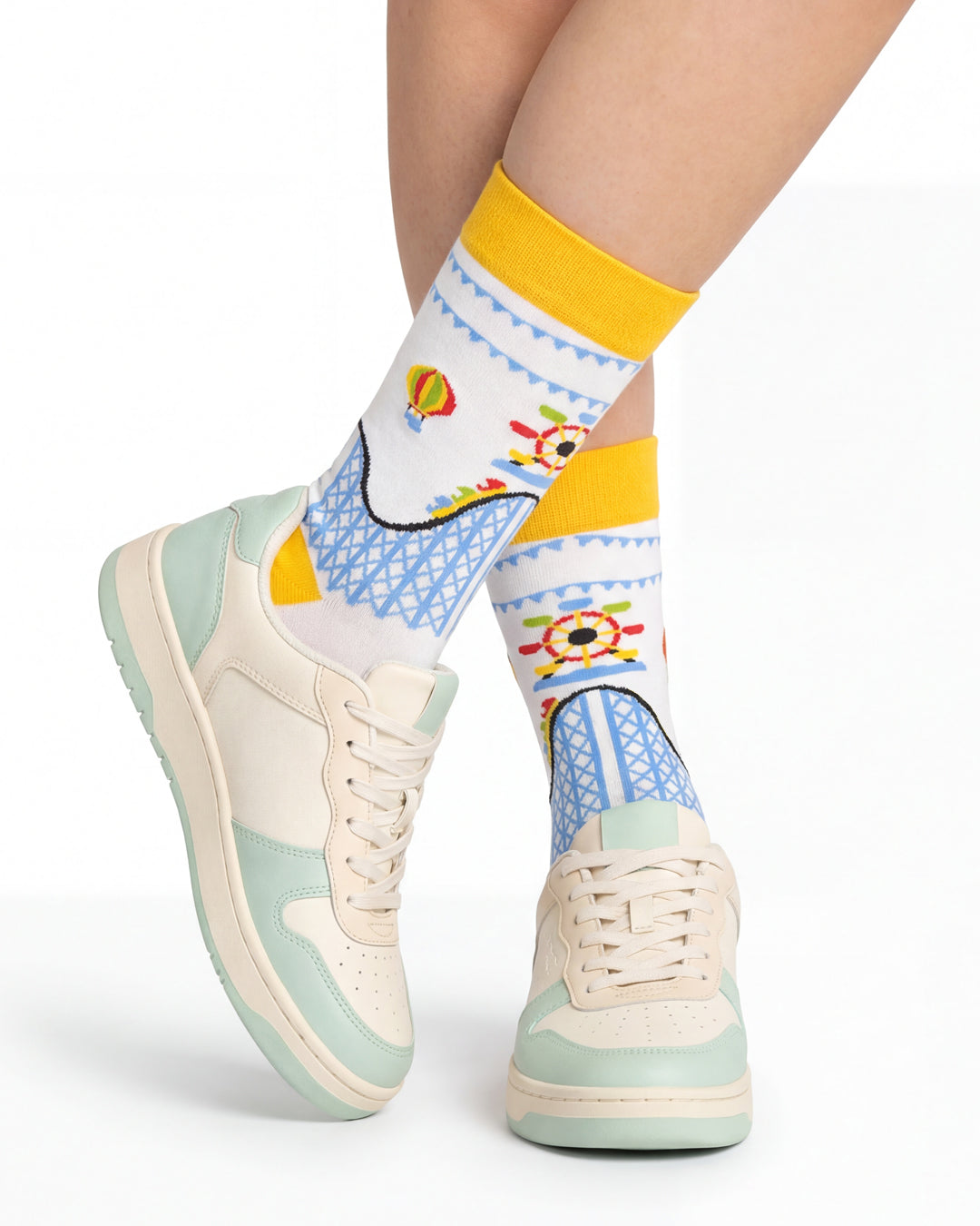 Socksop Amusement Park crew socks studio shot — carnival ride motifs in red yellow and blue on white cotton