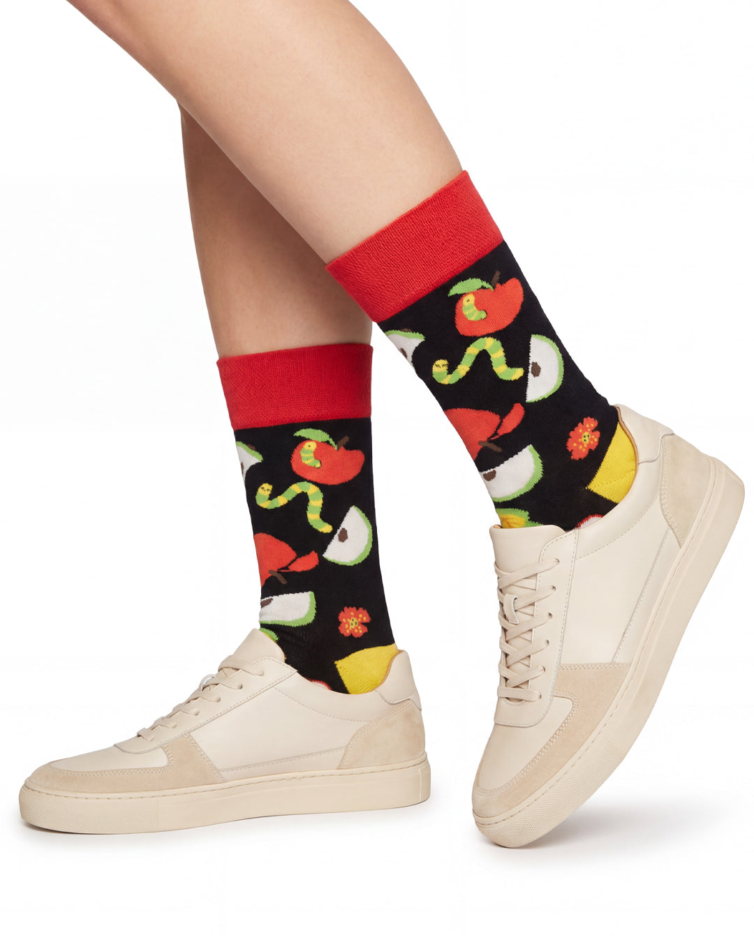 Socksop Apple crew socks studio shot — apple slices and worms in red green and yellow on black