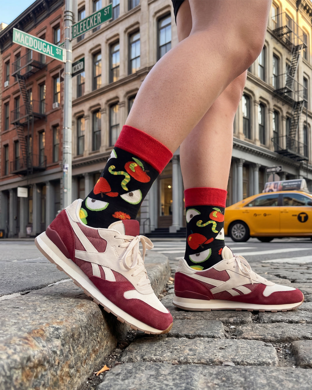 Socksop Apple crew socks lifestyle shot — apple-and-worm novelty design styled for everyday wear