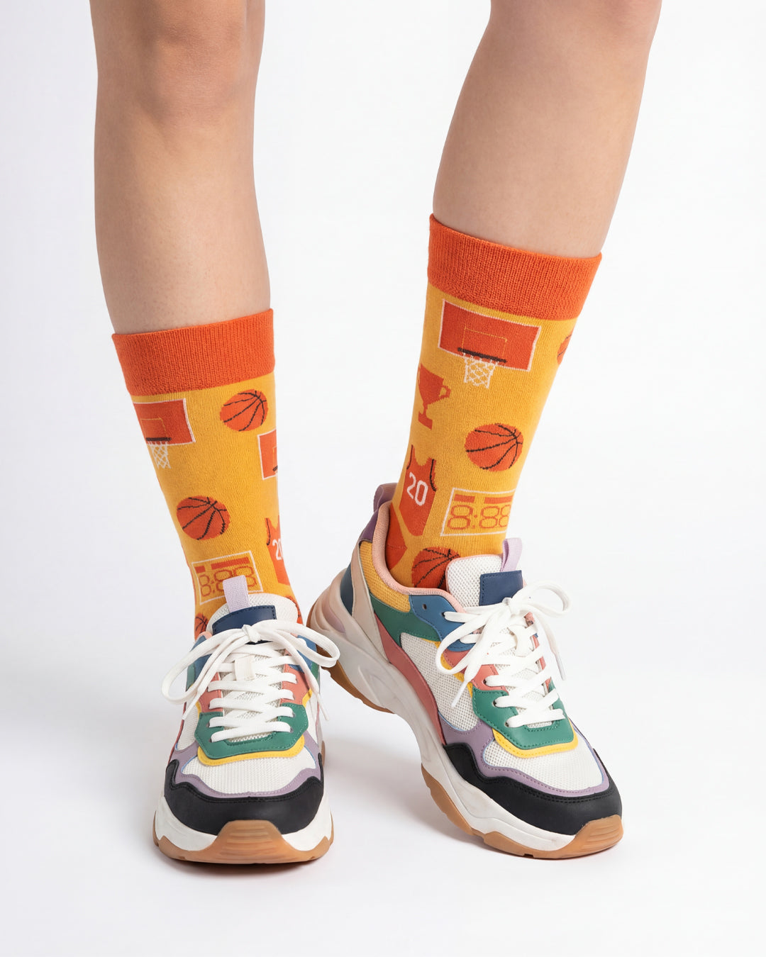 Socksop Basketball crew socks studio shot — court icons in orange with basketball motifs