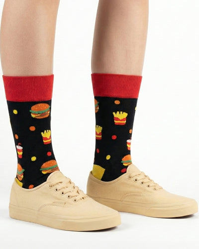 Socksop Burger crew socks studio shot — fast-food motifs in red yellow and orange on black