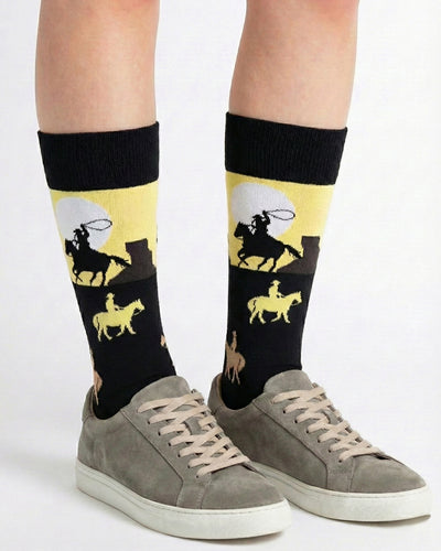 Socksop Cowboy crew socks studio shot — Western horseback silhouettes in tan and cream on black