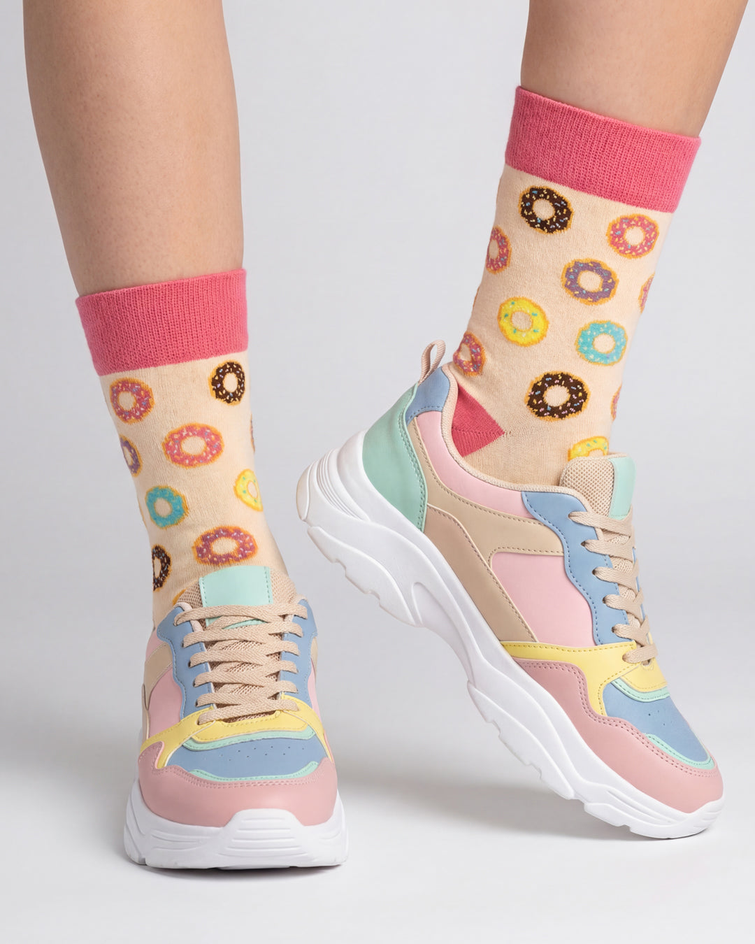 Socksop Donut crew socks studio shot — pastel sprinkled donuts on cream cotton
