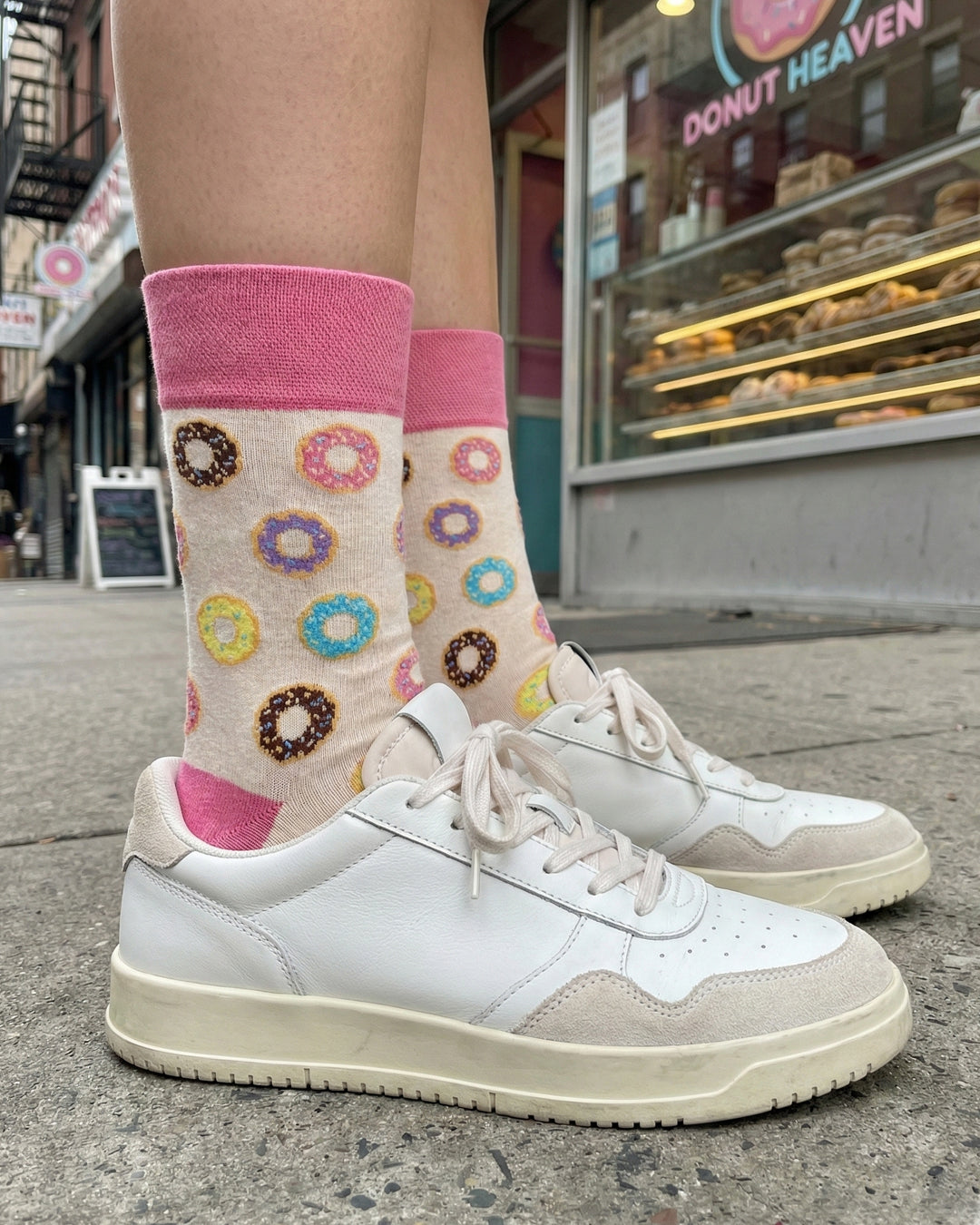 Socksop Donut crew socks worn outdoors — colorful donut pattern paired with sneakers