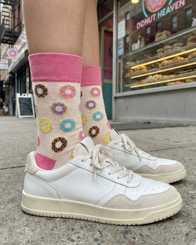 Socksop Donut crew socks worn outdoors — colorful donut pattern paired with sneakers