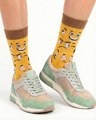 Socksop Emoji crew socks studio shot — playful expressive face icons on yellow cotton
