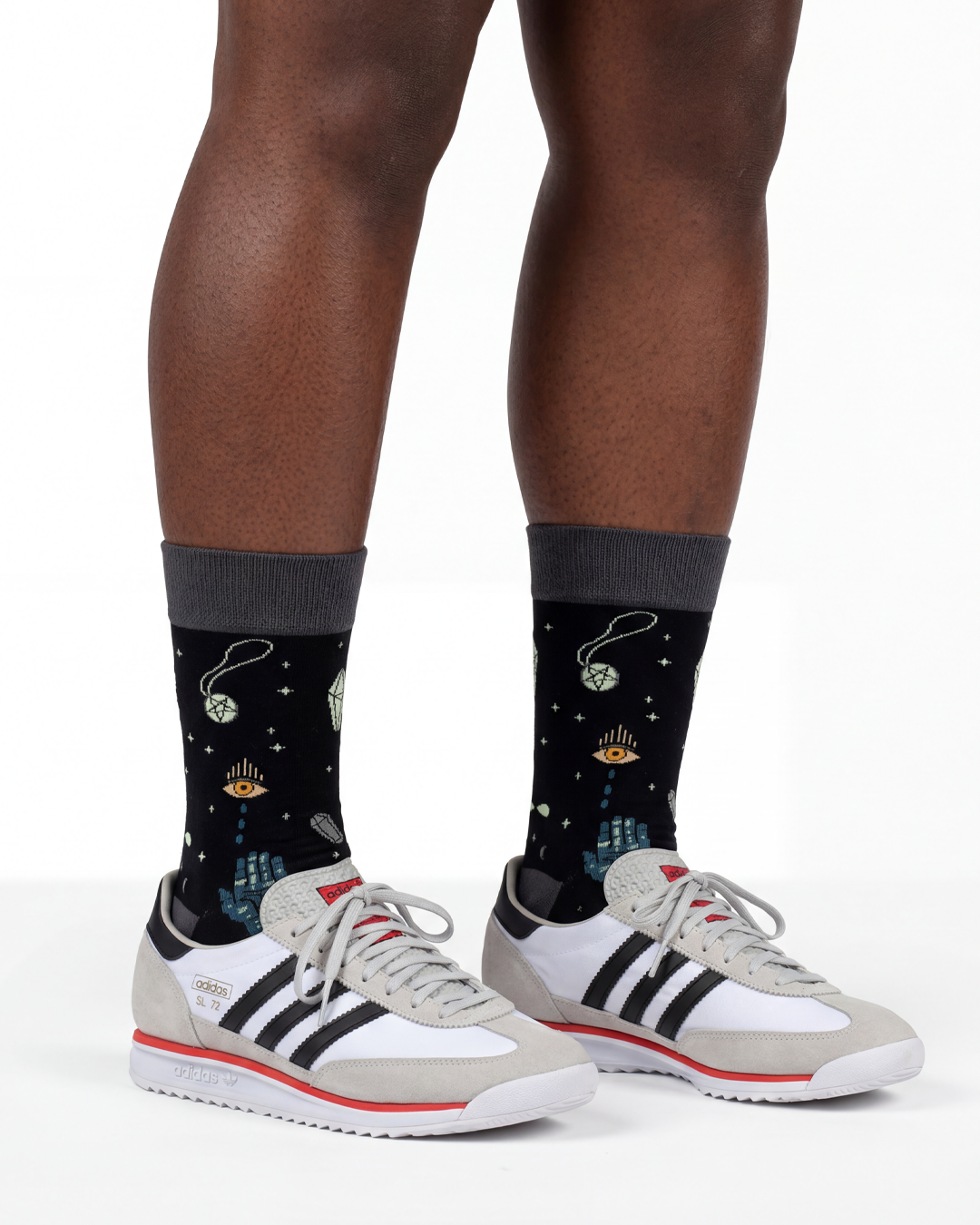 Socksop Esoteric Element crew socks studio shot — mystical occult symbols on black cotton