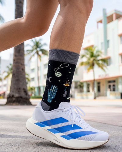 Socksop Esoteric Element crew socks worn outdoors — dark mystical pattern paired with boots