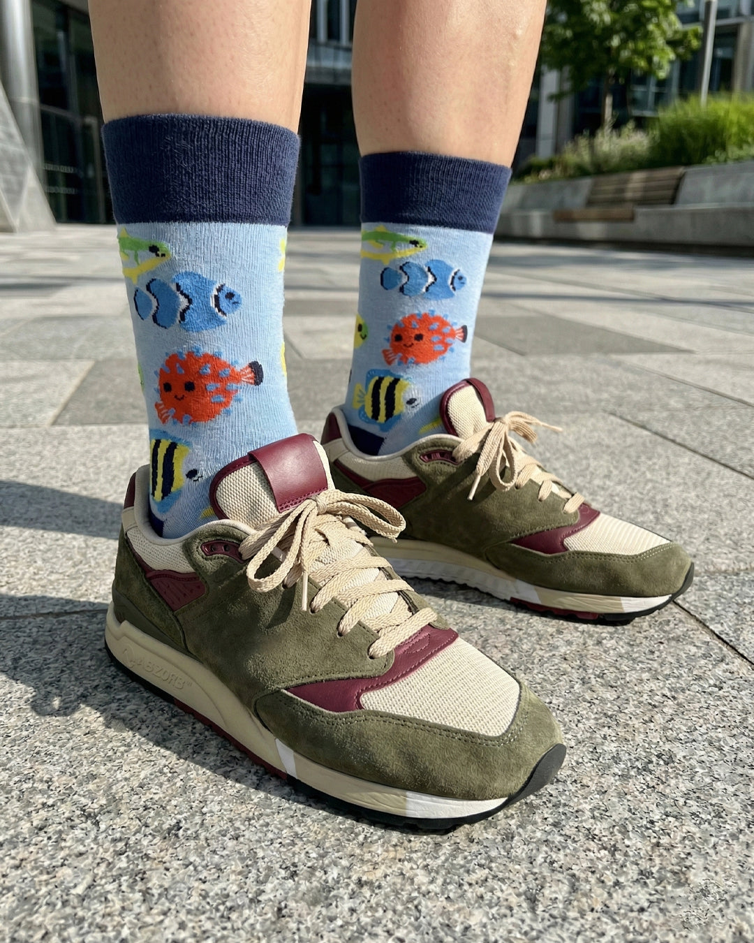 Socksop Fish crew socks worn outdoors — coral-reef themed pattern paired with sneakers