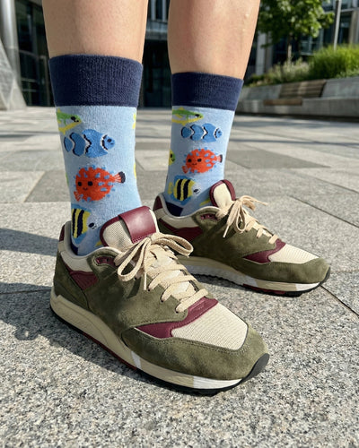Socksop Fish crew socks worn outdoors — coral-reef themed pattern paired with sneakers