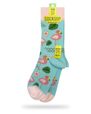 Socksop Flamingo crew socks — studio hero shot with pink flamingos monstera leaves and tropical flowers on aqua
