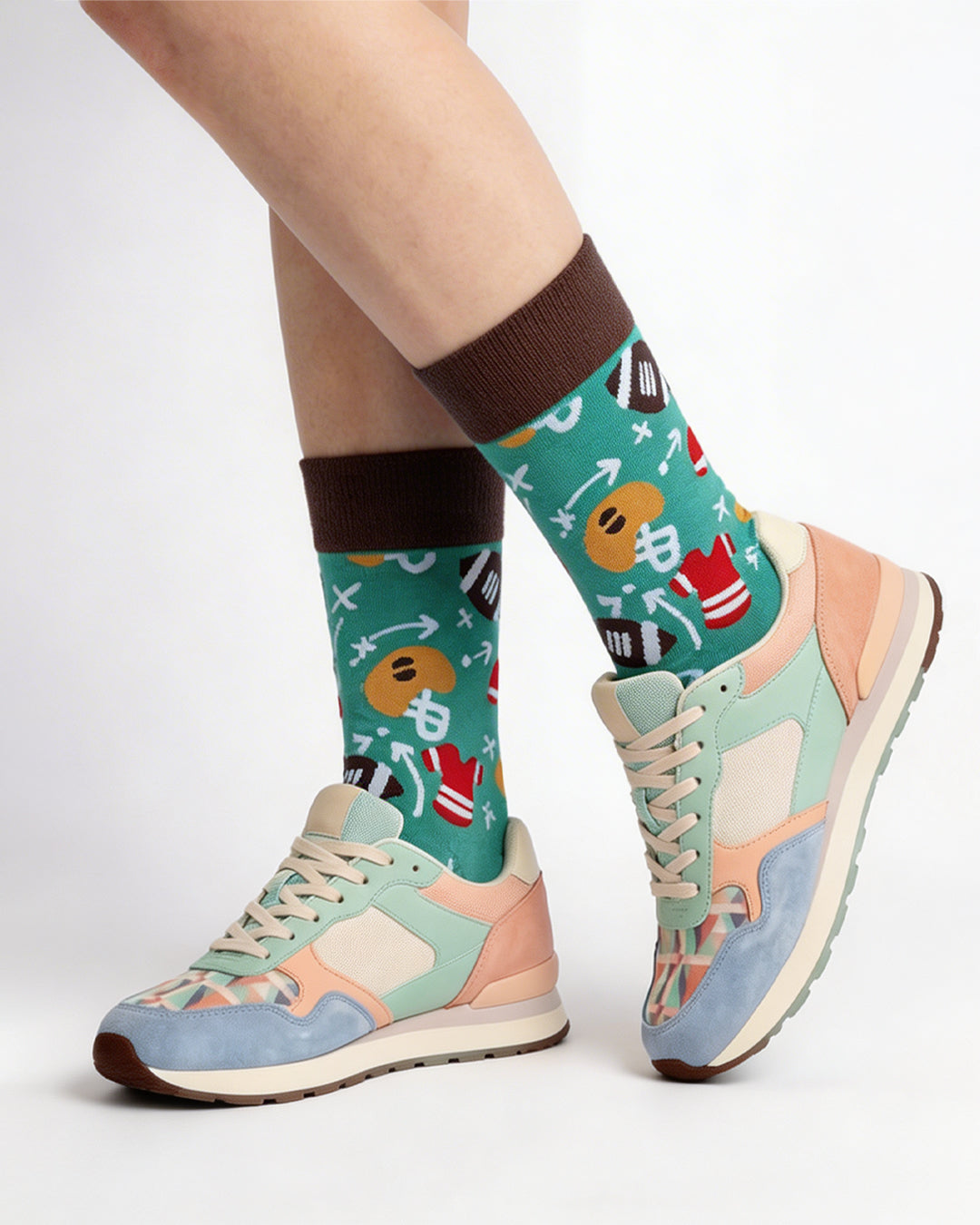 Socksop Football crew socks studio shot — gridiron motifs and play diagrams in green and brown