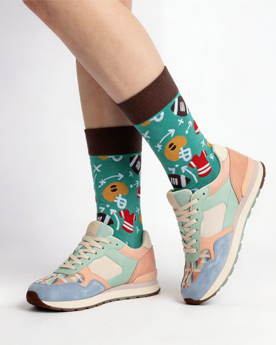 Socksop Football crew socks studio shot — gridiron motifs and play diagrams in green and brown