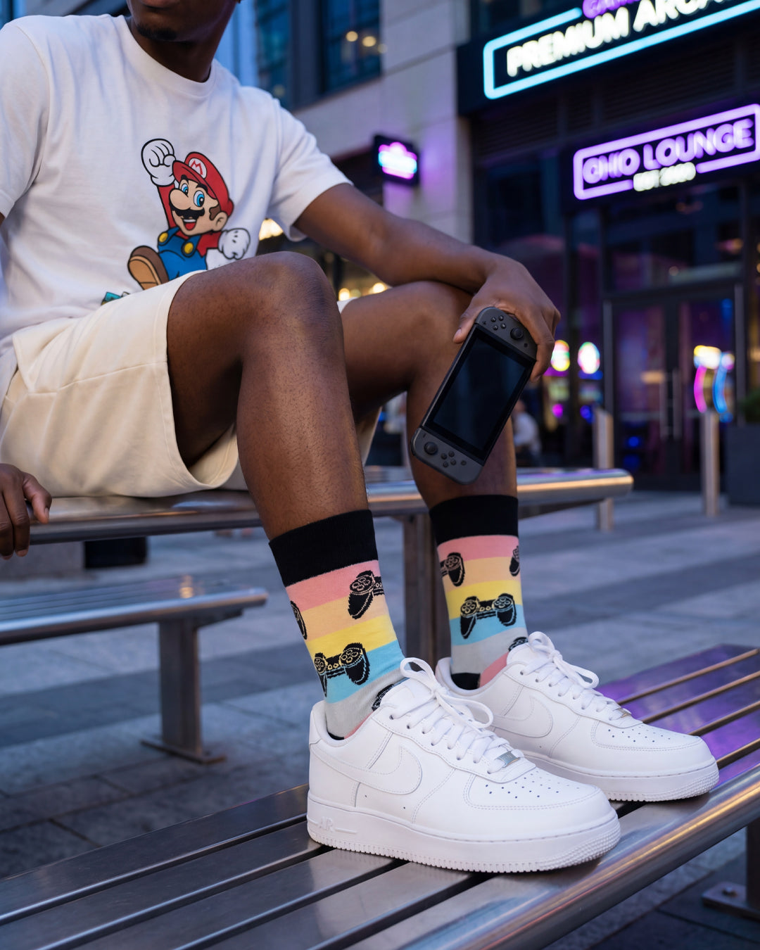 Socksop Gamer crew socks worn outdoors — colorful gamer-themed pattern paired with sneakers