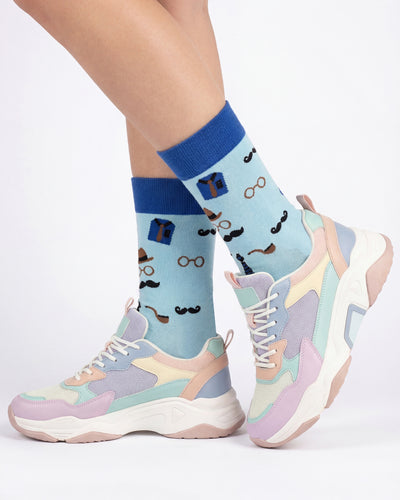 Socksop Gentleman crew socks studio shot — light blue with mustache pipe and bowler hat icons