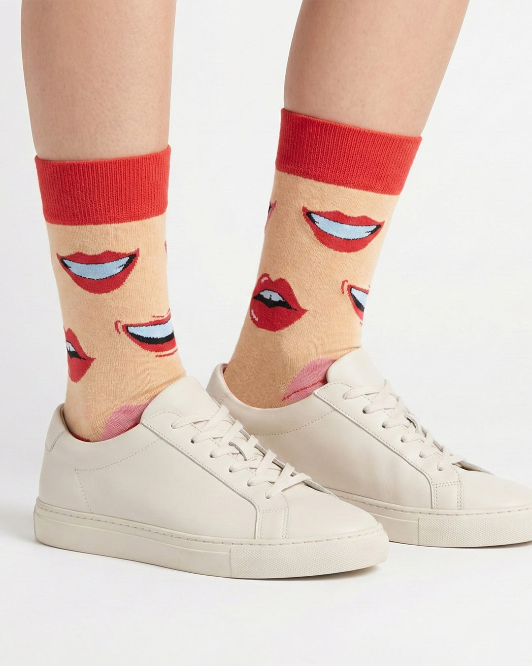 Socksop Lips crew socks studio shot — peach with red and pink kiss motifs