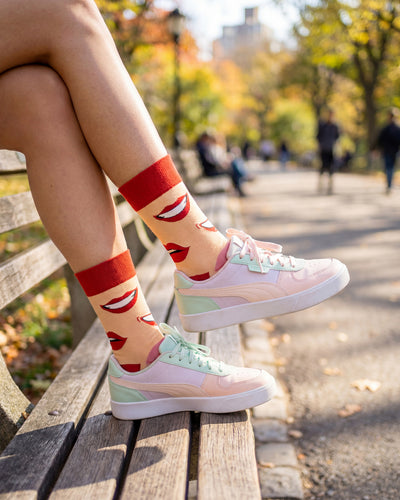 Socksop Lips crew socks worn outdoors — pop art kiss pattern in everyday setting