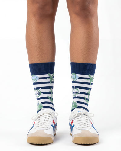 Socksop Nautical crew socks studio shot — navy stripes with anchor sailboat and starfish motifs