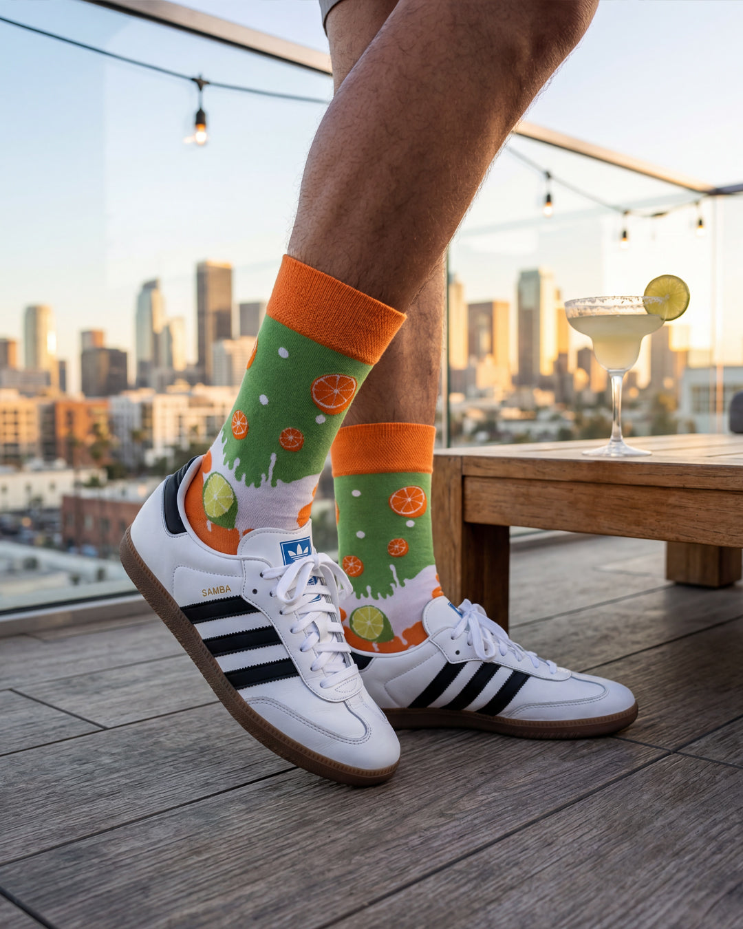 Socksop Orange and Lime crew socks lifestyle shot — citrus split styled with bright summer outfit