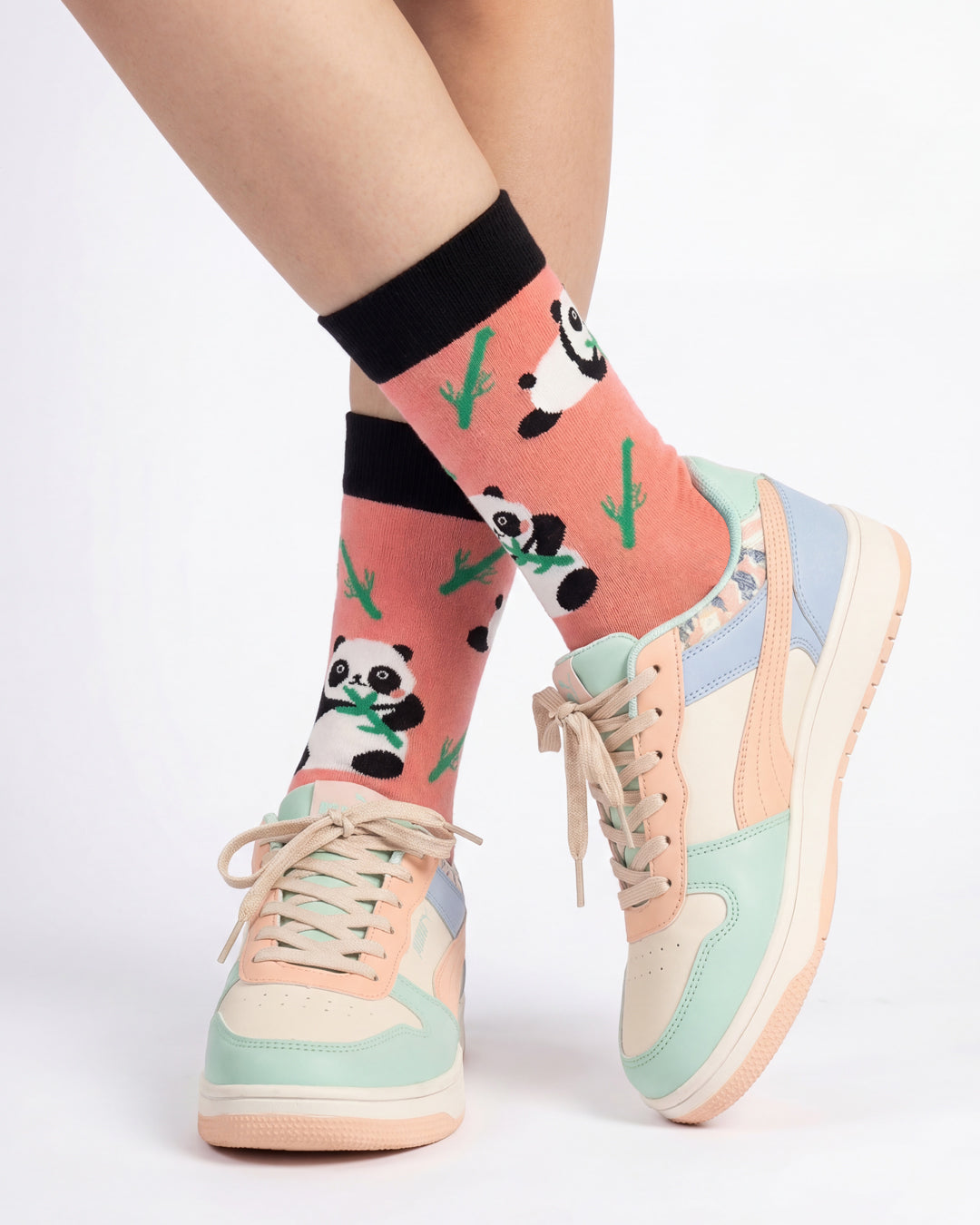 Socksop Panda crew socks studio shot — coral pink with panda and bamboo motifs