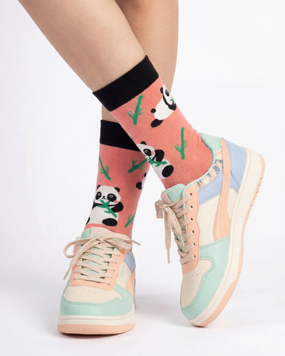 Socksop Panda crew socks studio shot — coral pink with panda and bamboo motifs