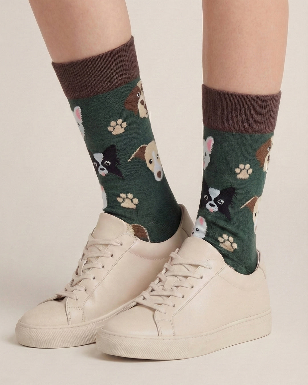 Socksop Paw crew socks studio shot — dark green with dog faces and paw print motifs