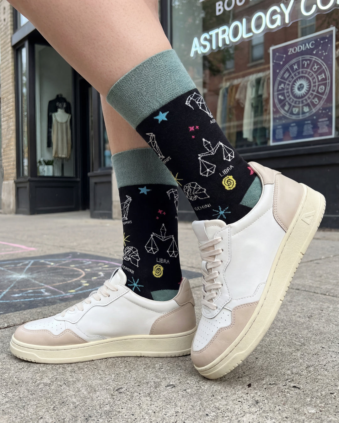Socksop Zodiac Signs crew socks worn outdoors — zodiac constellation pattern in casual scene